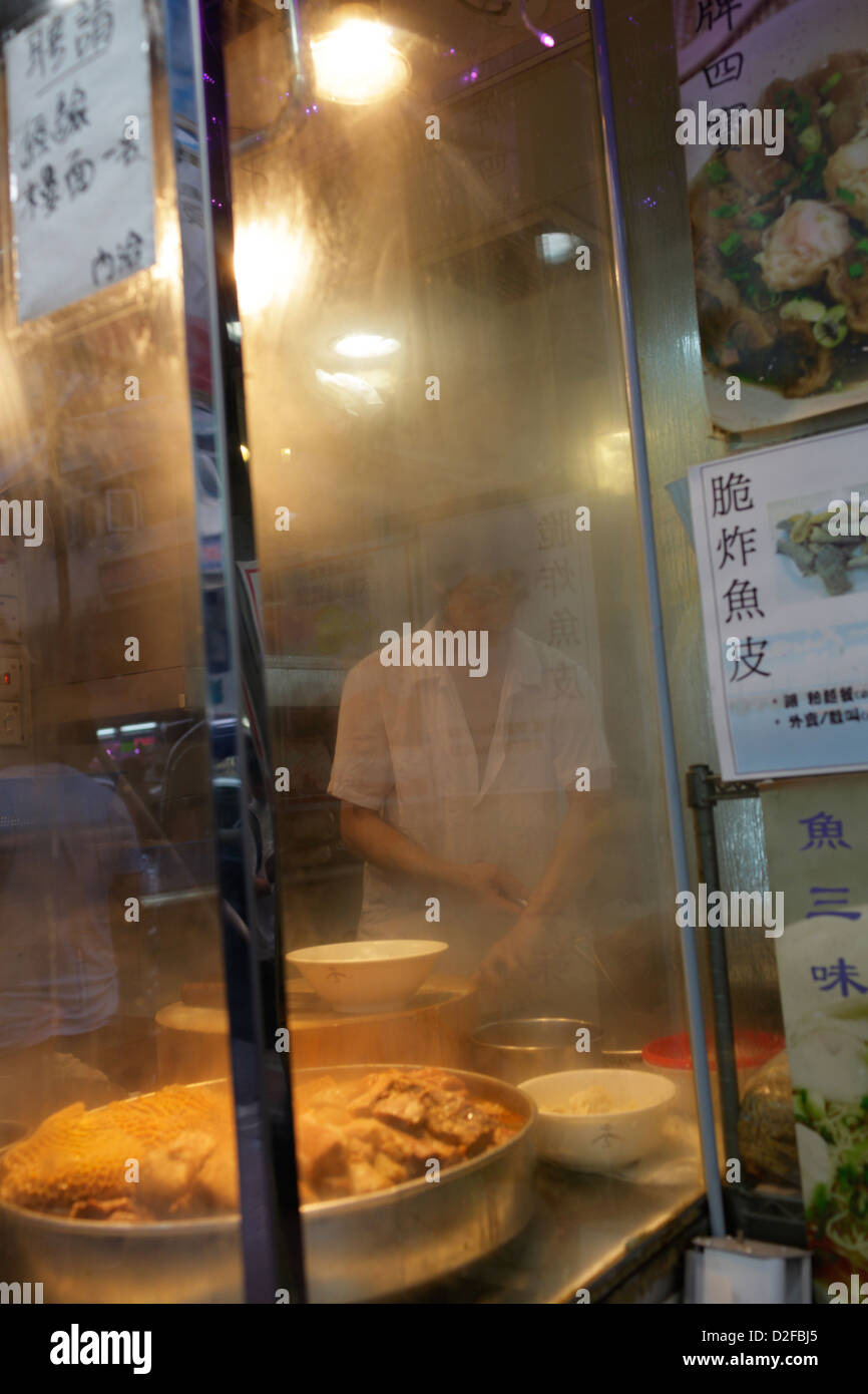 Hong Kong, China, a chef stands behind a fogged glass at a diner Stock Photo