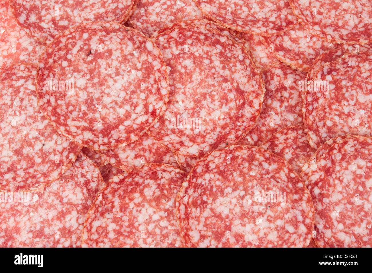 Salami background with many sliced pieces of salami Stock Photo - Alamy