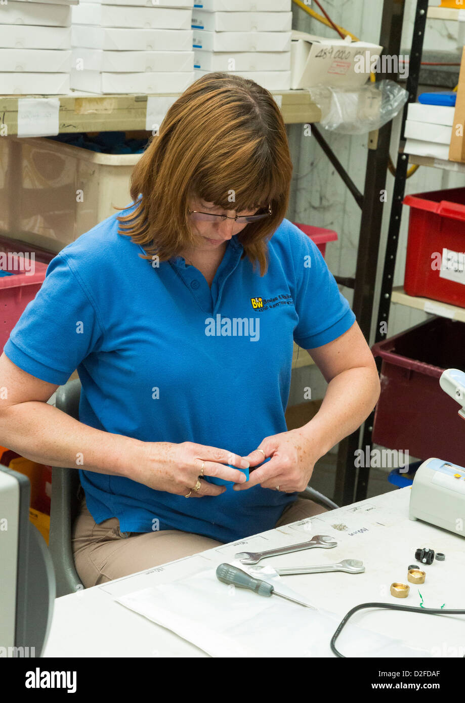 woman assembling electrical switches in a factory Stock Photo
