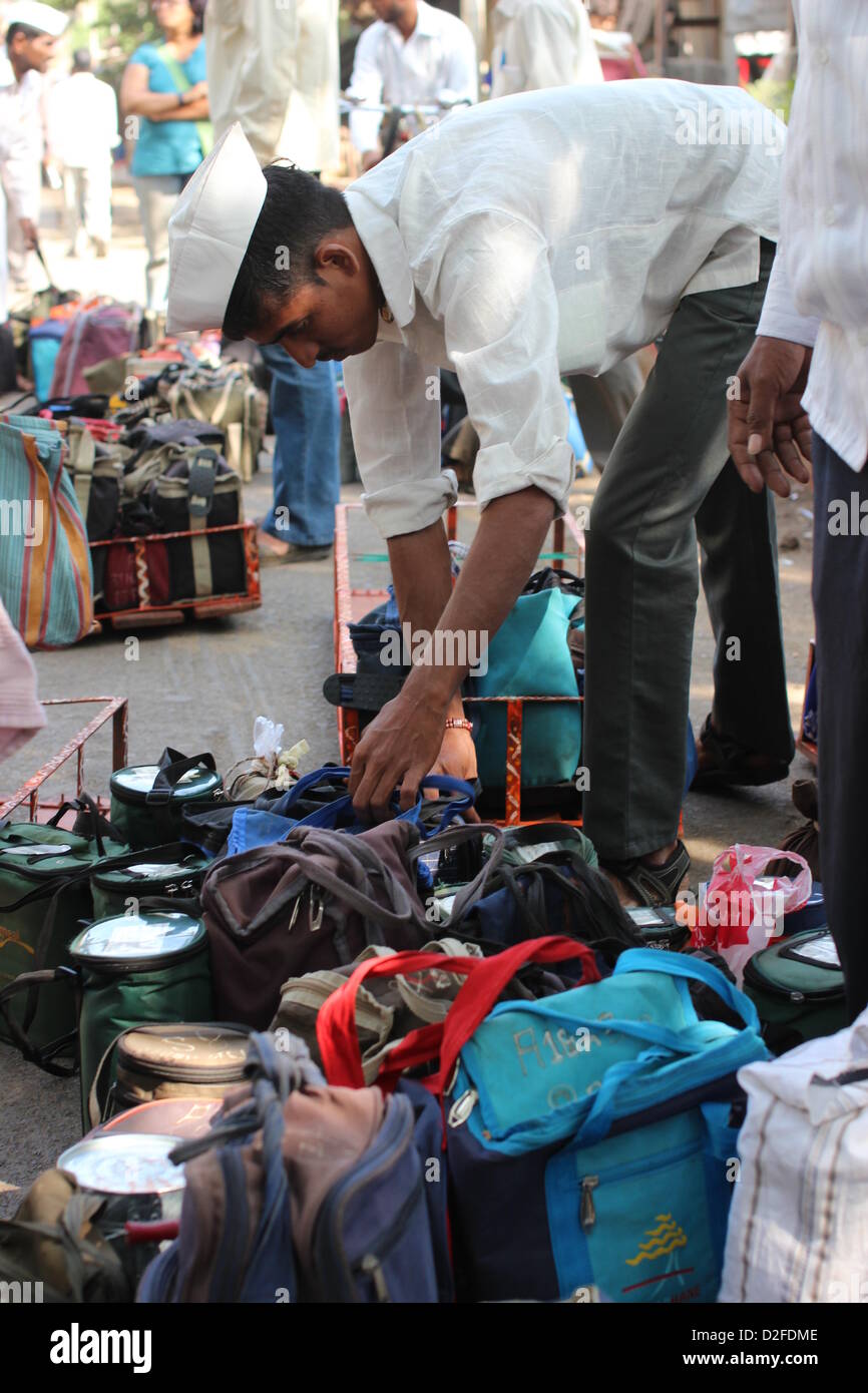 Dabbawalas pack food together for delivery at Andheri Station in Mumbai, India, 20 November 2012. 5,000 food delivers take 175,000 lunches to workplaces every day in Mumbai. Photo: Doreen Fiedler Stock Photo