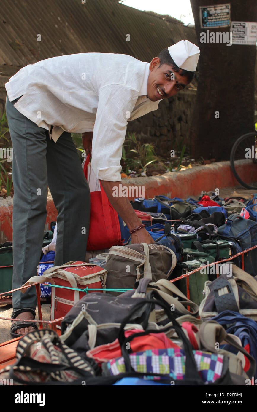 Dabbawalas pack food together for delivery at Andheri Station in Mumbai, India, 20 November 2012. 5,000 food delivers take 175,000 lunches to workplaces every day in Mumbai. Photo: Doreen Fiedler Stock Photo