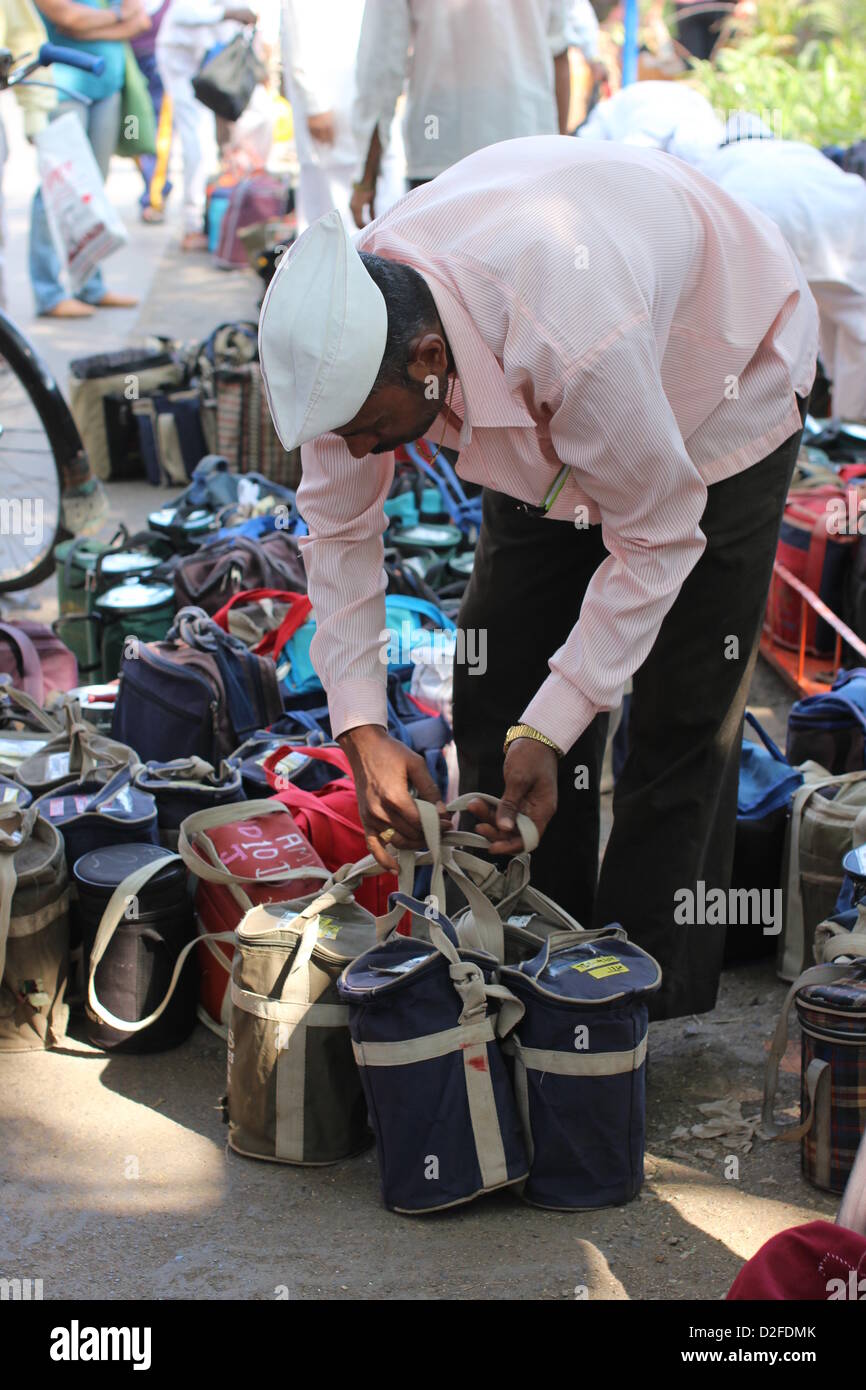 Dabbawalas pack food together for delivery at Andheri Station in Mumbai, India, 20 November 2012. 5,000 food delivers take 175,000 lunches to workplaces every day in Mumbai. Photo: Doreen Fiedler Stock Photo