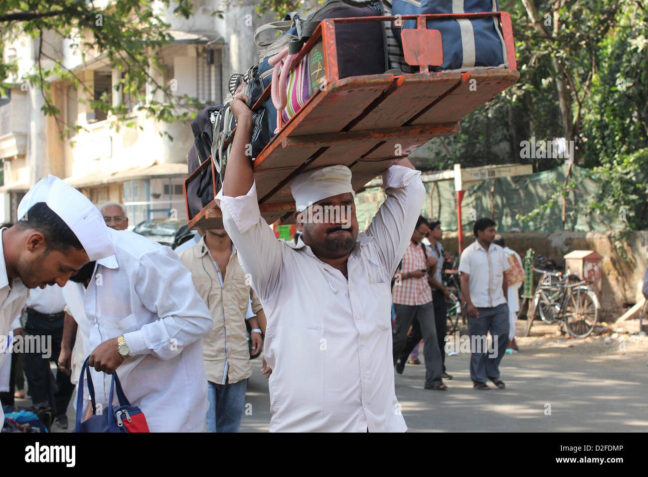Dabbawalas pack food together for delivery at Andheri Station in Mumbai, India, 20 November 2012. 5,000 food delivers take 175,000 lunches to workplaces every day in Mumbai. Photo: Doreen Fiedler Stock Photo