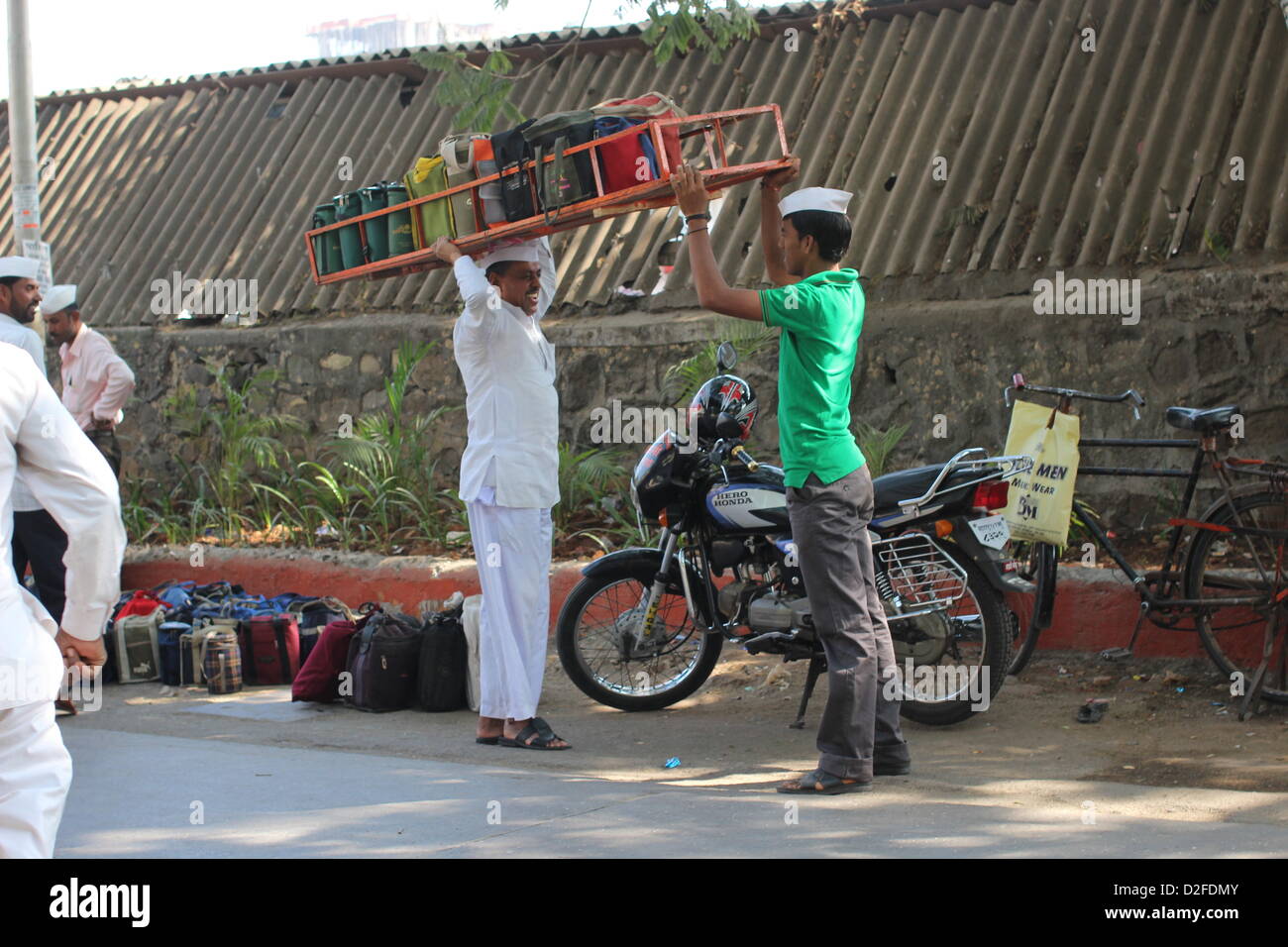 Dabbawalas pack food together for delivery at Andheri Station in Mumbai, India, 20 November 2012. 5,000 food delivers take 175,000 lunches to workplaces every day in Mumbai. Photo: Doreen Fiedler Stock Photo