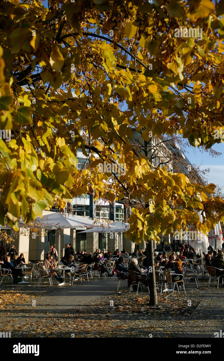 Berlin, Germany, tourists sit in the fall in the street cafes on Spreeufe Stock Photo
