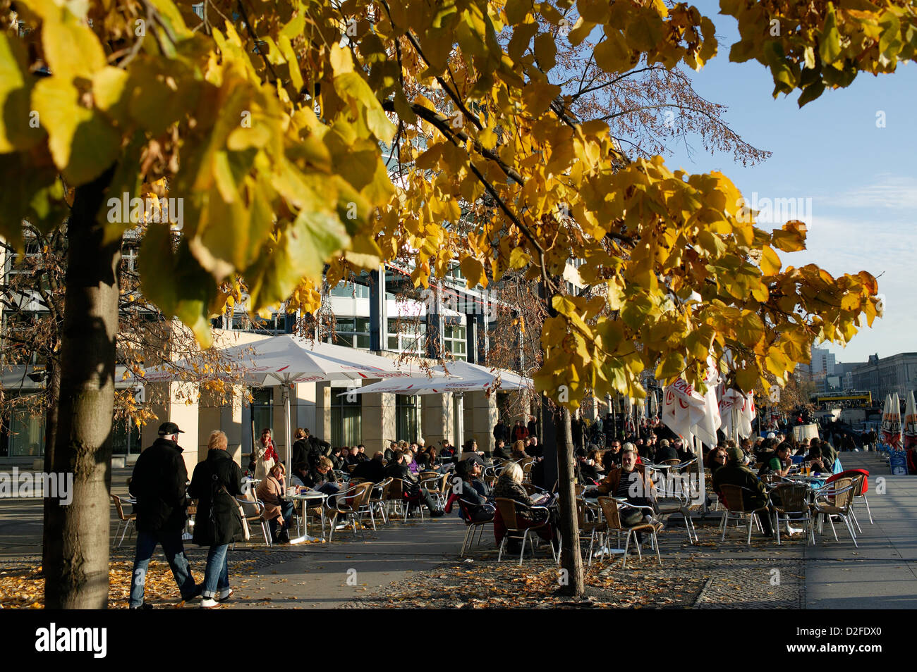 Berlin, Germany, tourists sit in the fall in the street cafes on Spreeufe Stock Photo