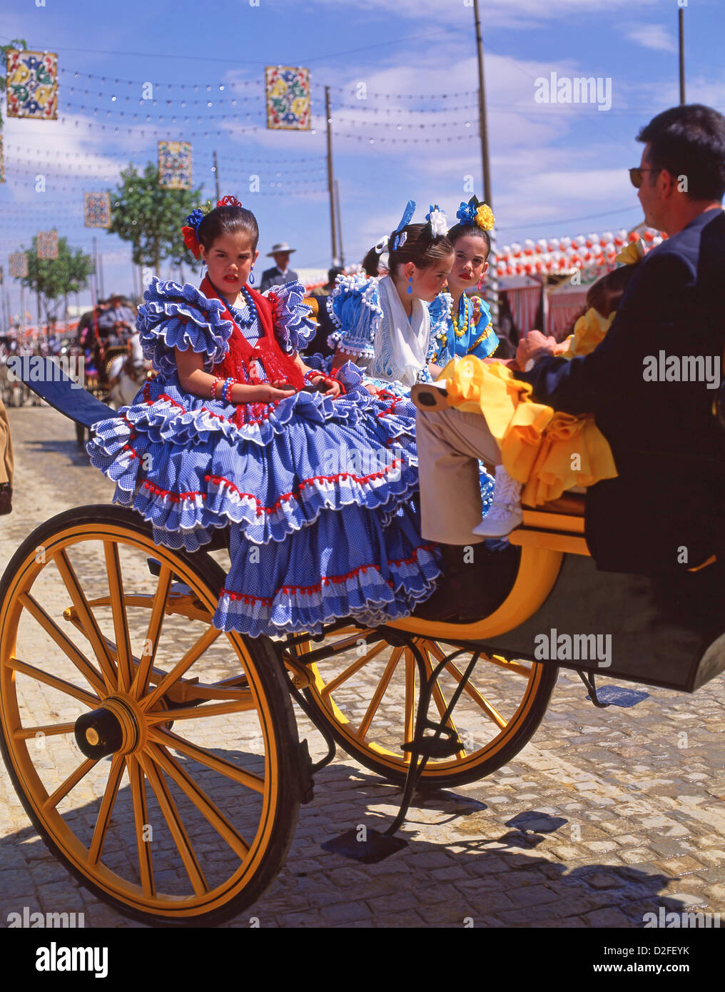 Girls in flamenco dress on carriage, Feria de abril de Sevilla (Seville April Fair), Seville, Sevilla Province, Andalucia, Spain Stock Photo