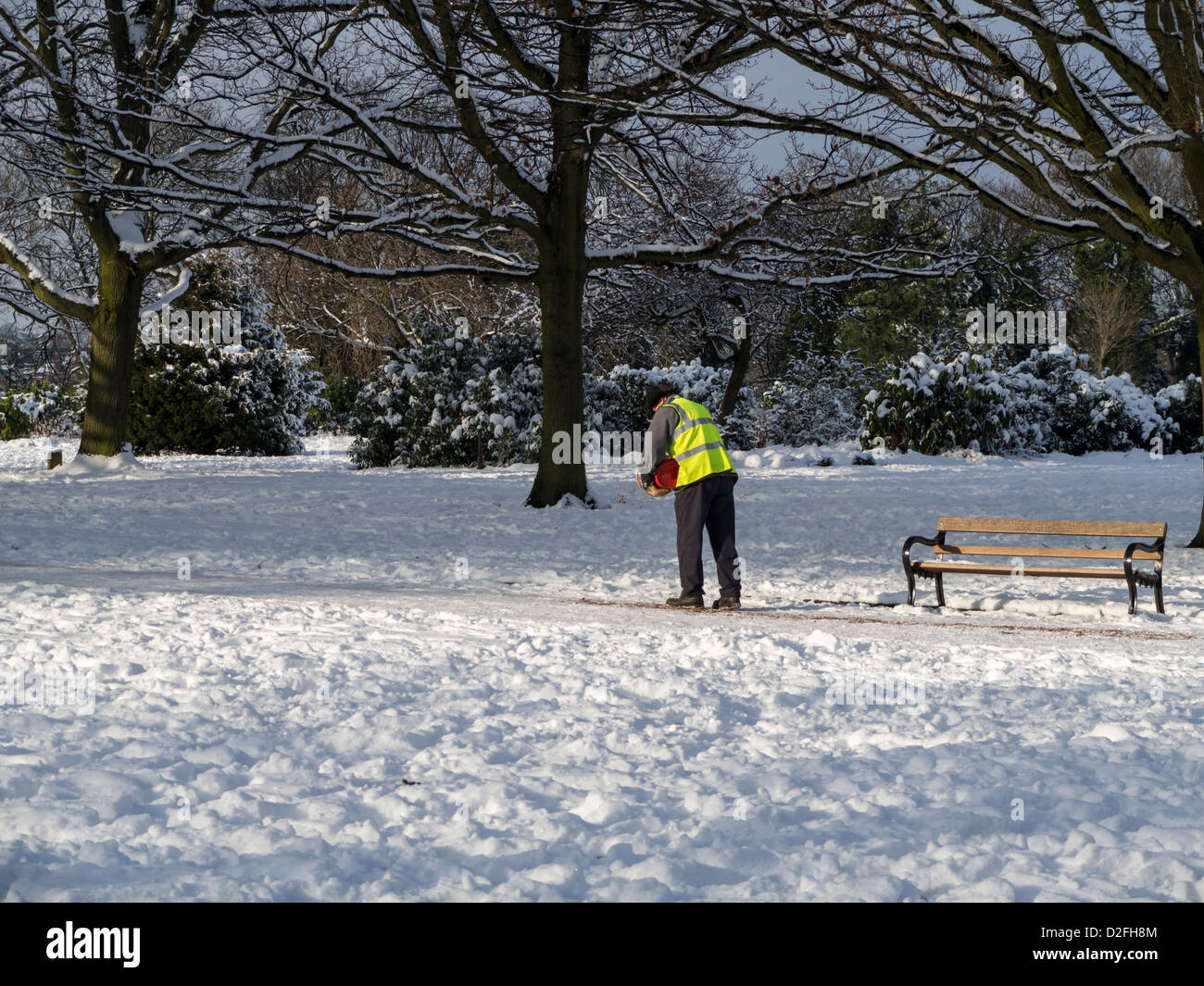 Sheffield City Council workers carrying shovels and gritting footpaths in Weston Park Sheffield South Yorkshire after heavy snow Stock Photo