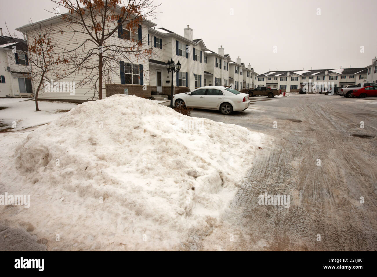 large piles of snow piled up for removal from residential area Saskatoon Saskatchewan Canada Stock Photo