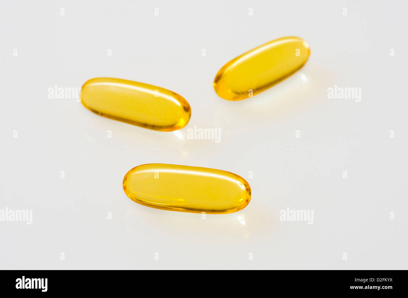 Fish Oil Capsules on an off-white reflective background Stock Photo