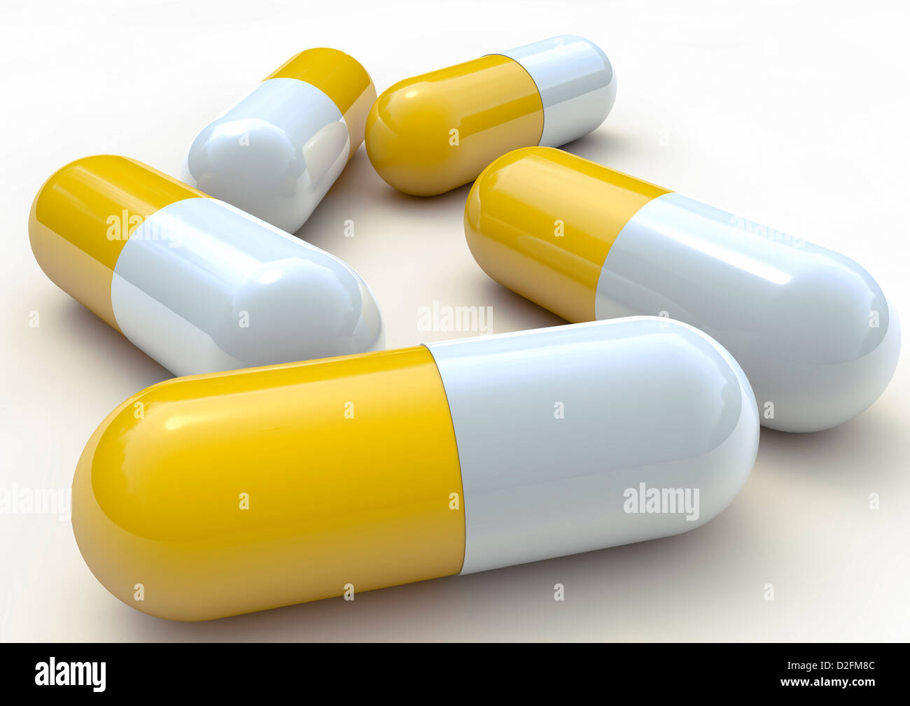 Close up of yellow and white plastic pill capsules on white background Stock Photo