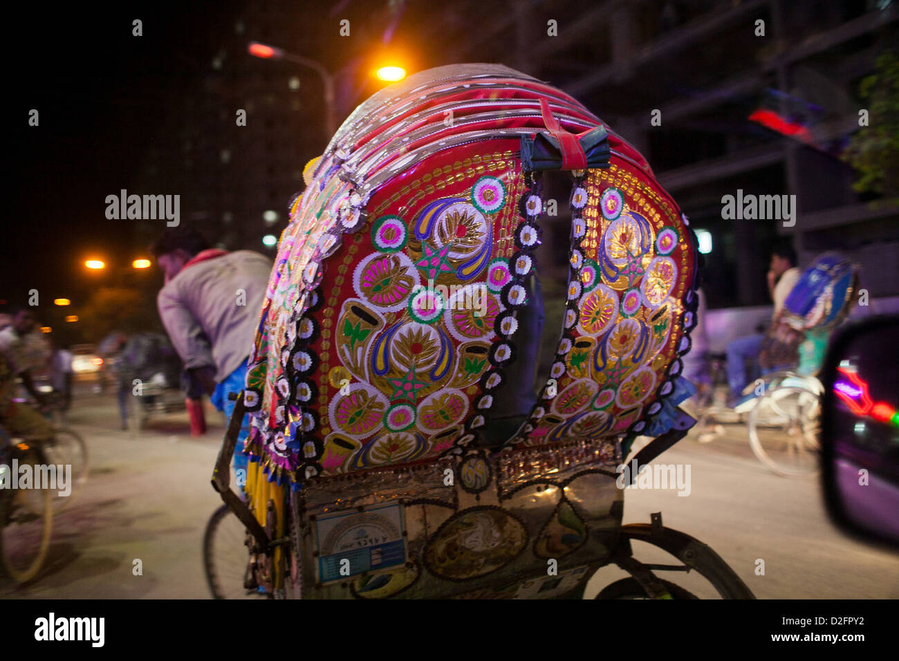 A rickshaw at night in Dhaka. The rickshaw is the cheapest and preferred mode of transport to many in Dhaka. Stock Photo