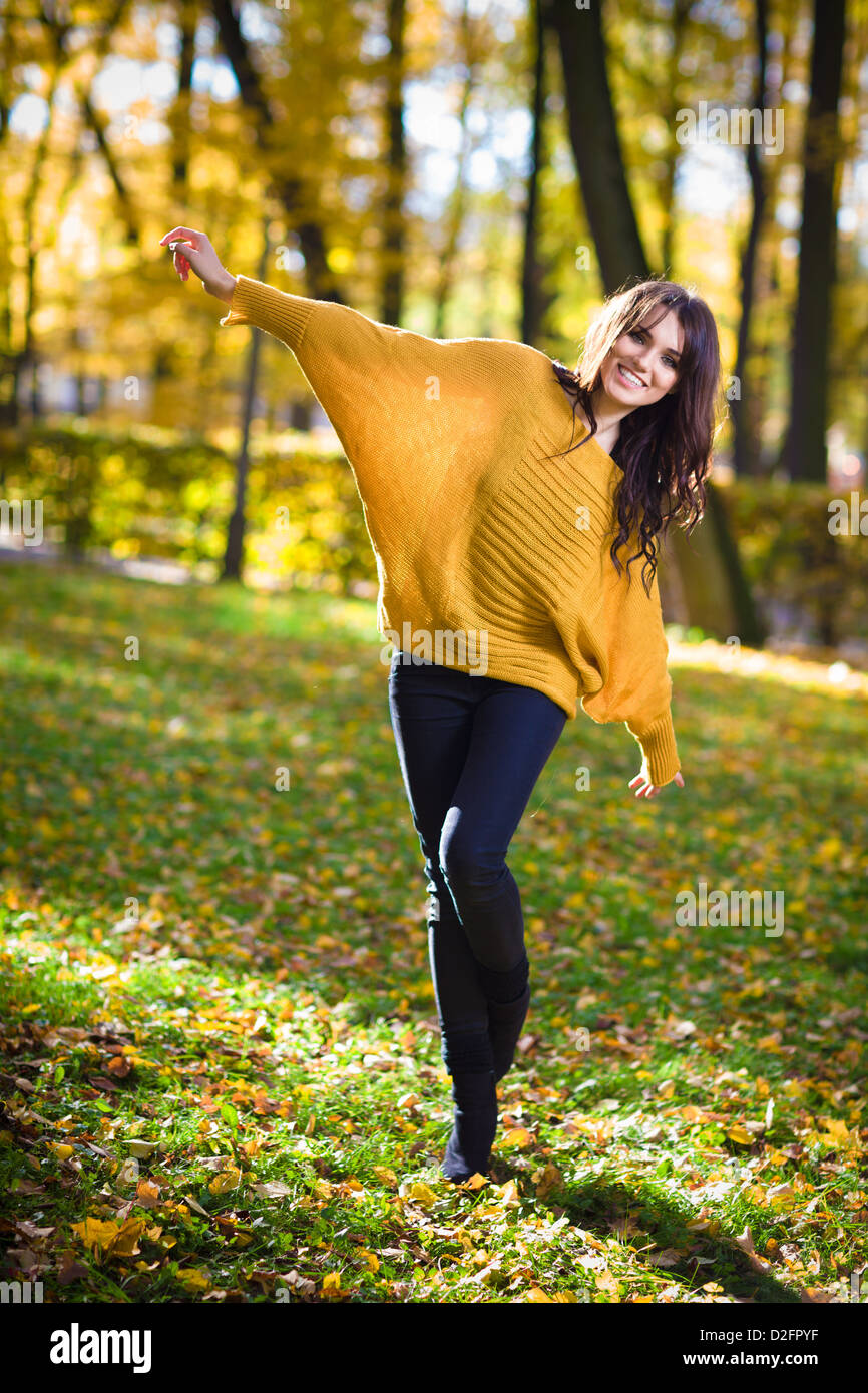 Happy woman dance in autumn park Stock Photo