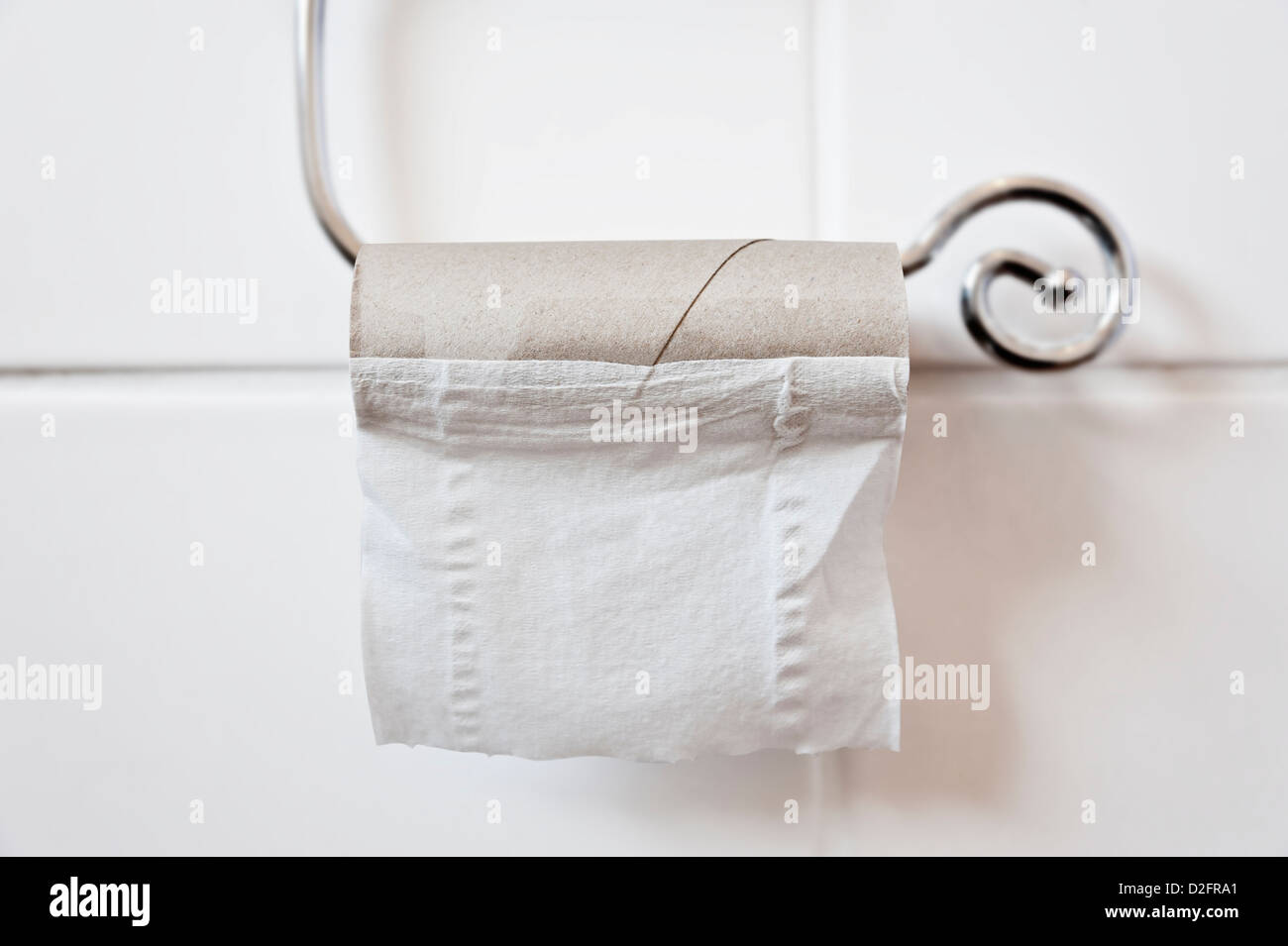 Last sheet of toilet paper on a toilet roll Stock Photo