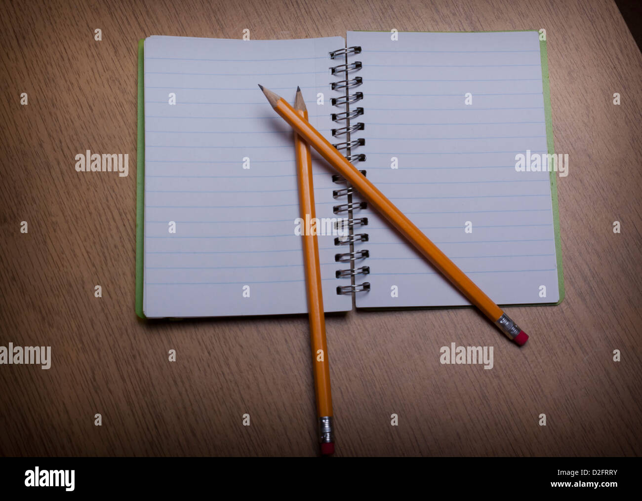 open notebook on a wooden desk with pencil Stock Photo