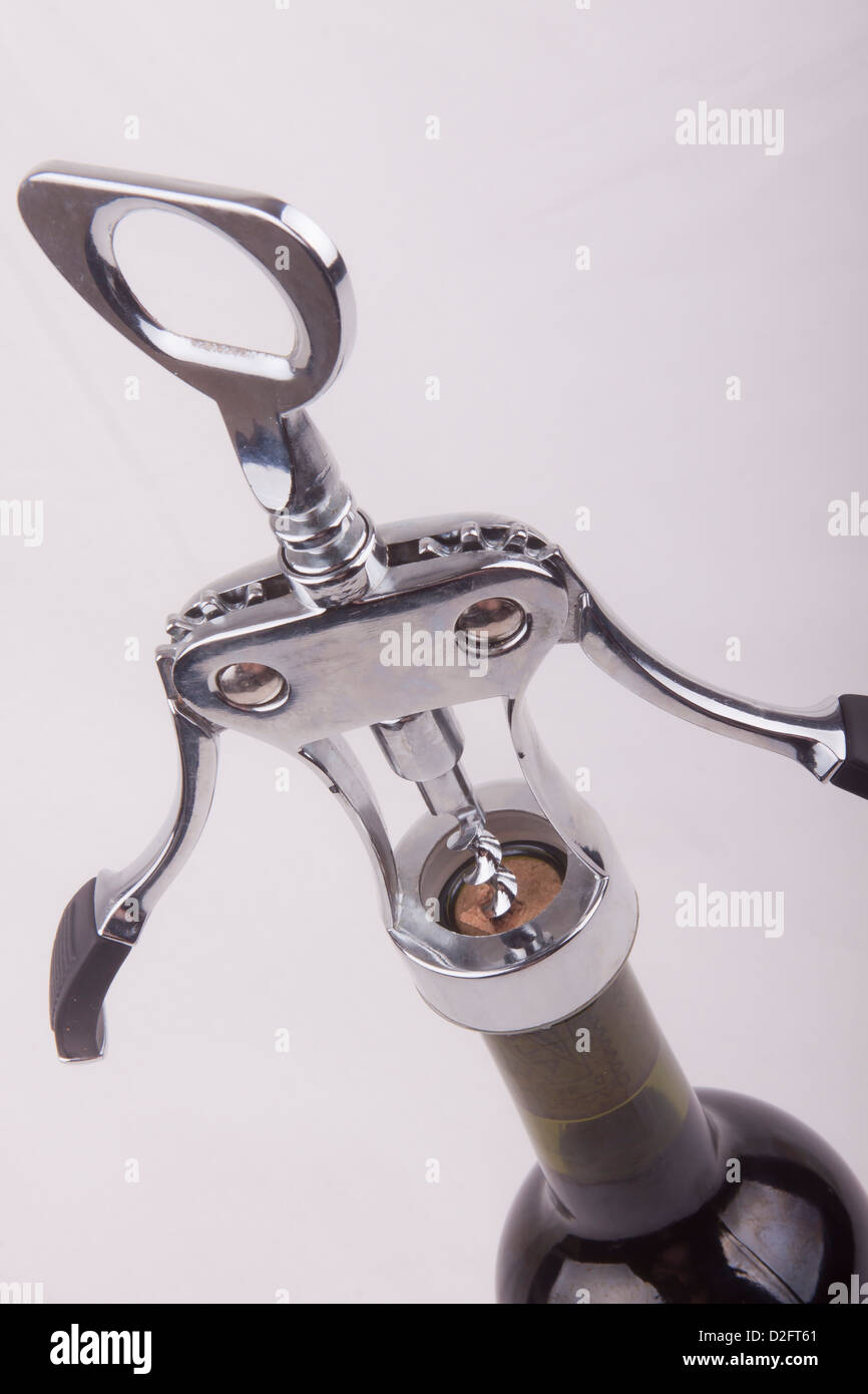 wine bottle with a corkscrew on a white background Stock Photo - Alamy
