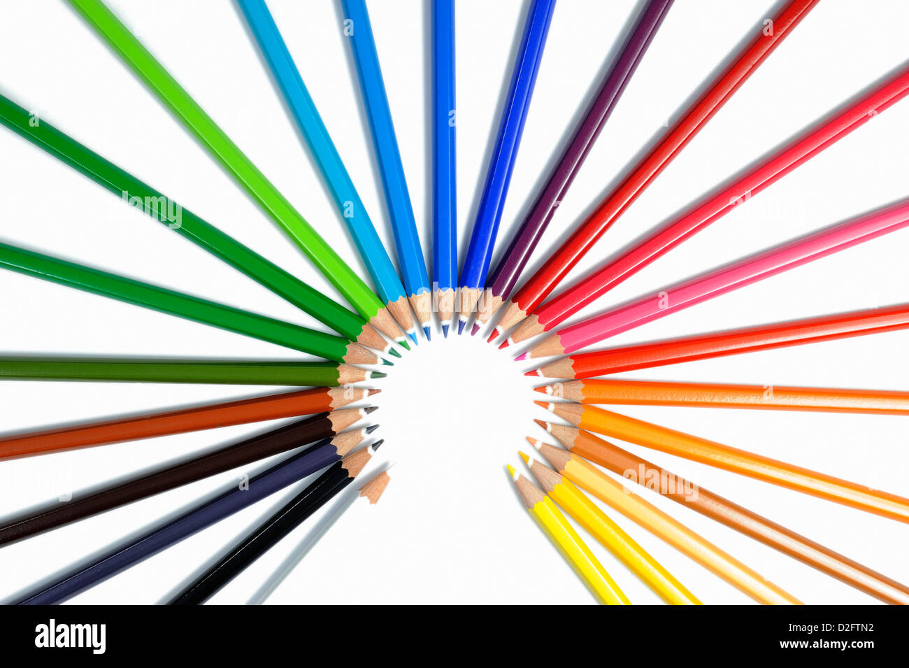 Colorful crayons in circle, on white background, studio shot Stock Photo