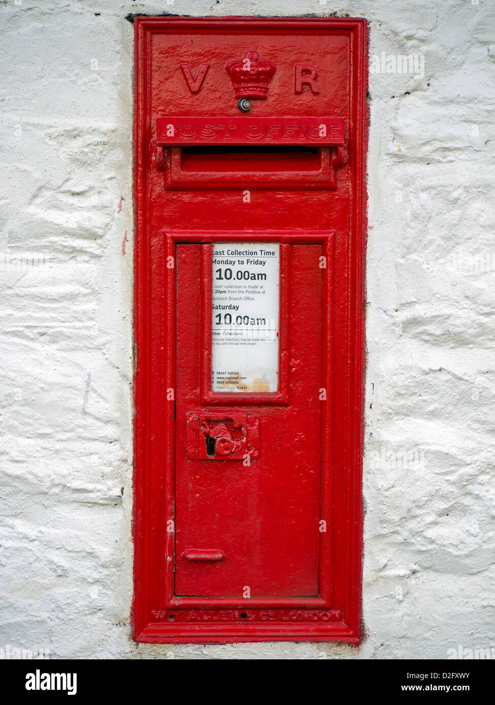 Red Victorian postbox set in wall. Stock Photo