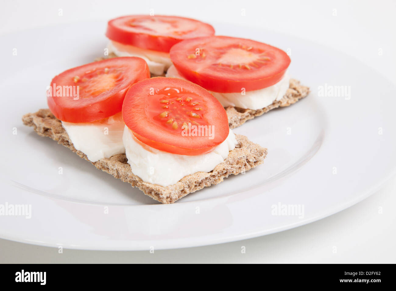 Crispbreads with tomato slices and cheese Stock Photo