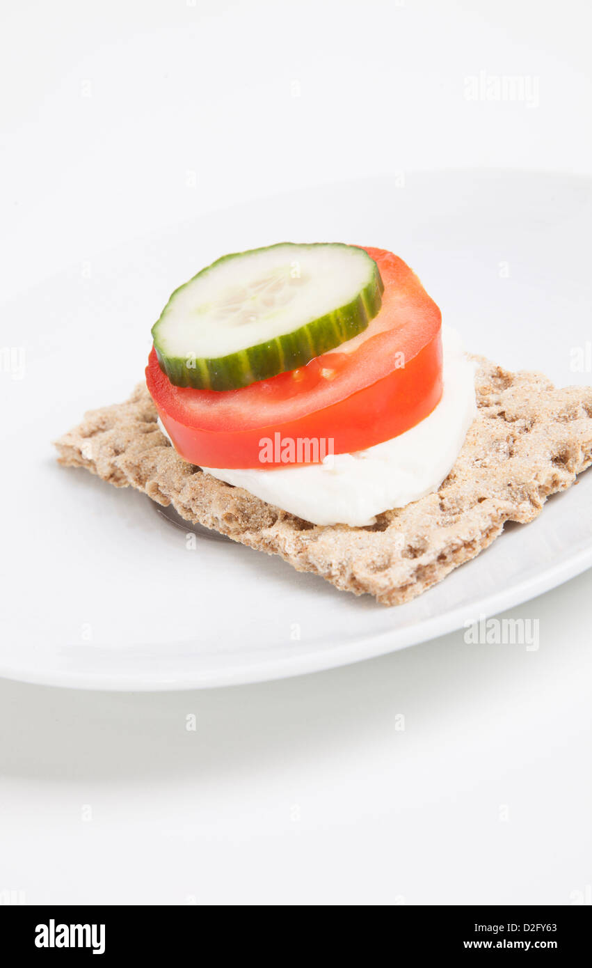 Crispbread with tomato and cucumber slice and cheese Stock Photo