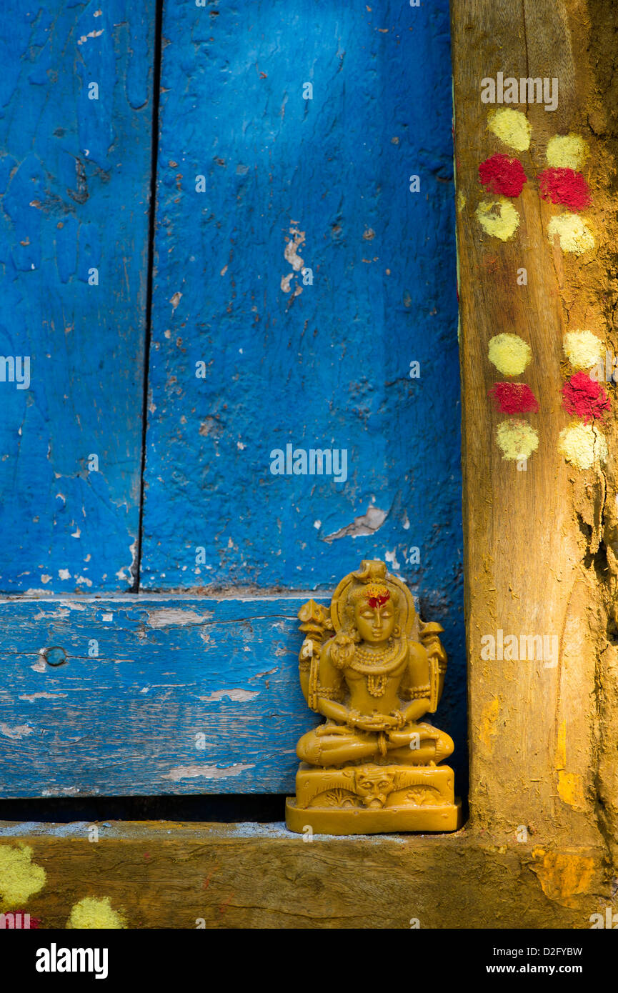 Lord Shiva statue outside village temple doorway. India Stock Photo