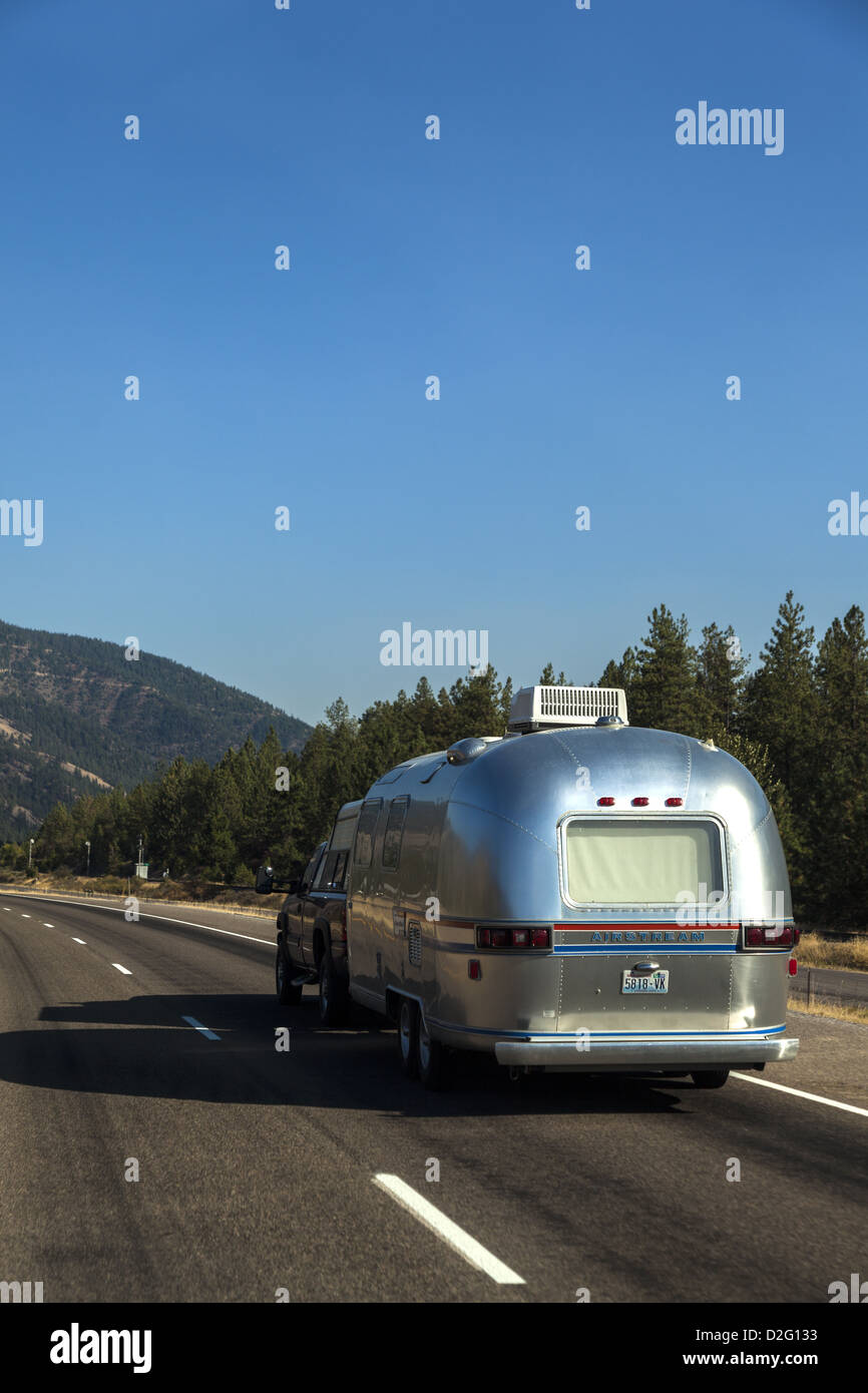 A classic silver Airstream travel trailer on I-90 in Montana USA Stock Photo