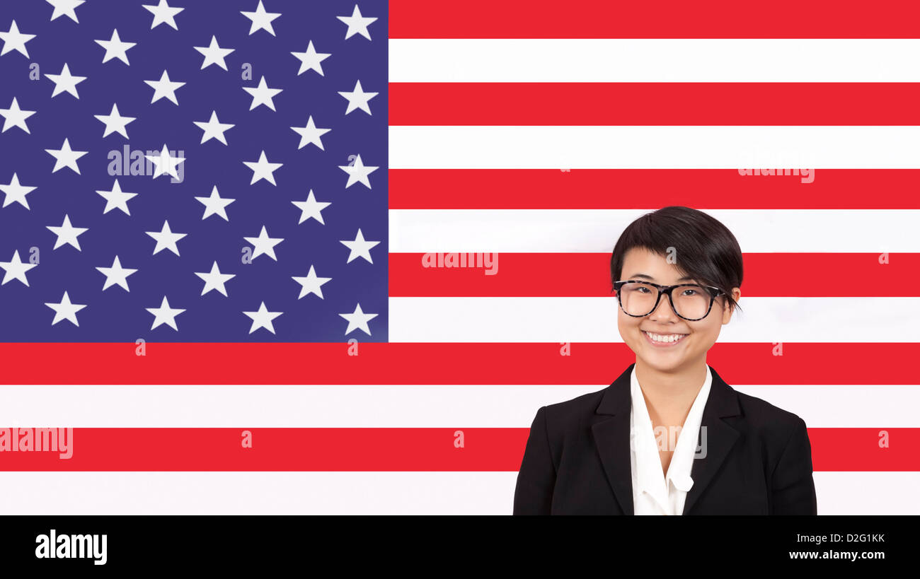 Portrait of young businesswoman smiling over American flag Stock Photo ...