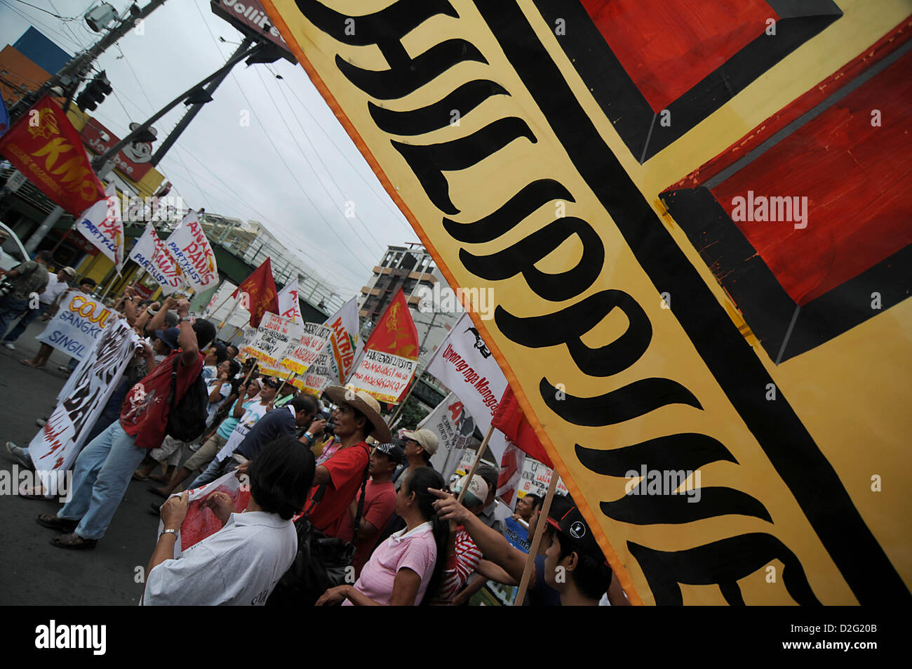 Manila, Philippines. 22nd January 2013. Demonstrators stage a protest at the Mendiola Peace Arch, outside the presidential palace, in Manila, Philippines, Tuesday, Jan. 22, 2013, during the 26th anniversary of the Mendiola Massacre. Various groups marched to the Mendiola Peace Arch to commemorate the 26th anniversary of the Mendiola Massacre which saw 13 people killed after police opened fire on demonstrators pressing for land reform. Credit:  Ezra Acayan / Alamy Live News Stock Photo