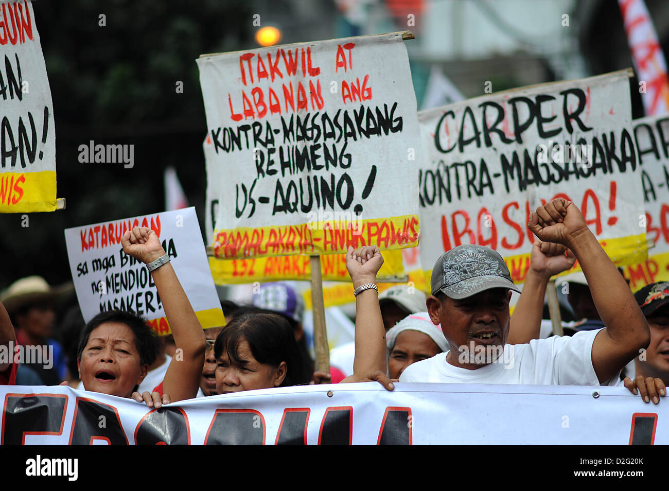 Manila, Philippines. 22nd January 2013. Demonstrators stage a protest at the Mendiola Peace Arch, outside the presidential palace, in Manila, Philippines, Tuesday, Jan. 22, 2013, during the 26th anniversary of the Mendiola Massacre. Various groups marched to the Mendiola Peace Arch to commemorate the 26th anniversary of the Mendiola Massacre which saw 13 people killed after police opened fire on demonstrators pressing for land reform. Credit:  Ezra Acayan / Alamy Live News Stock Photo
