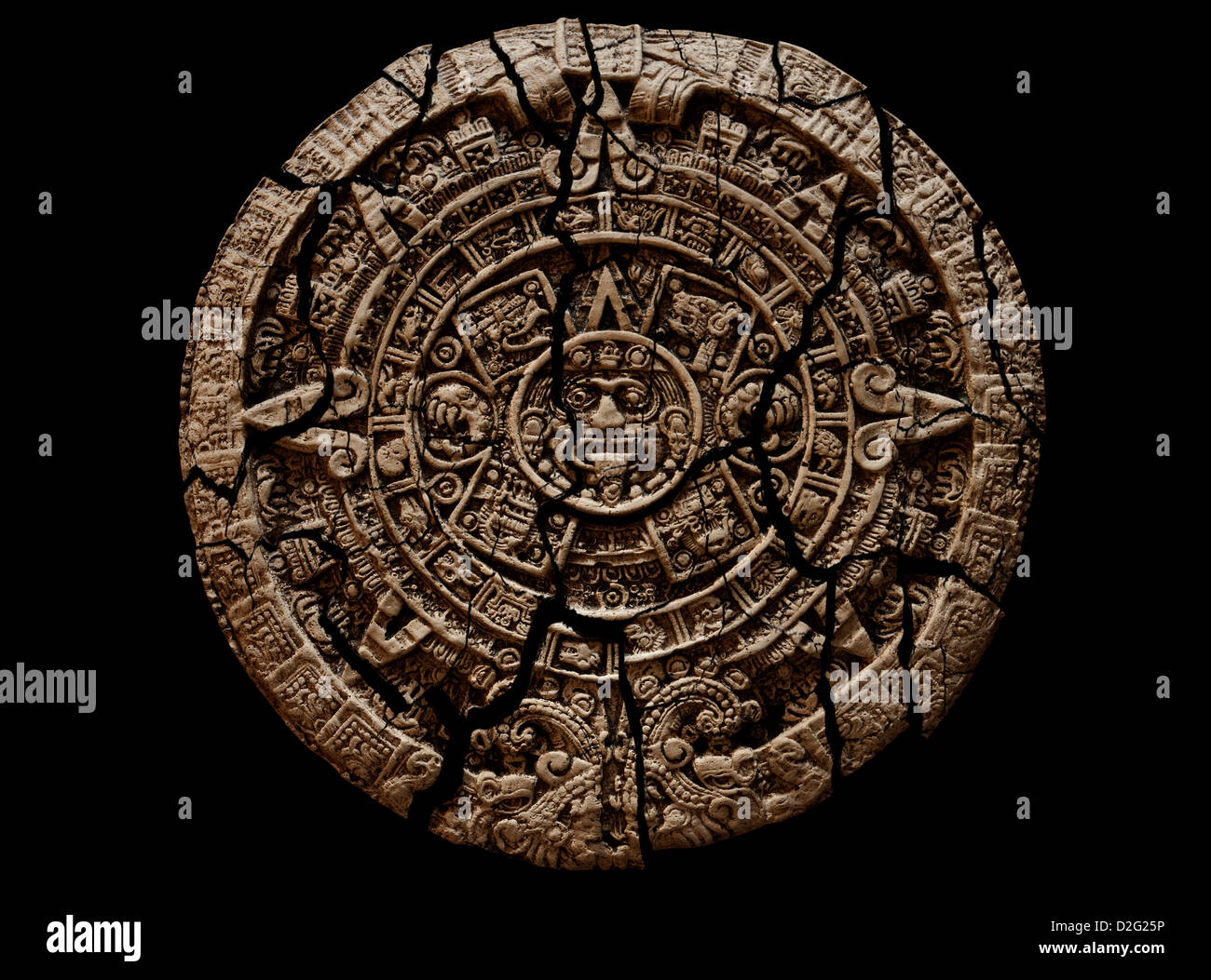Cracked and crumbling Mayan calendar stone tablet on black background. Cutout Stock Photo