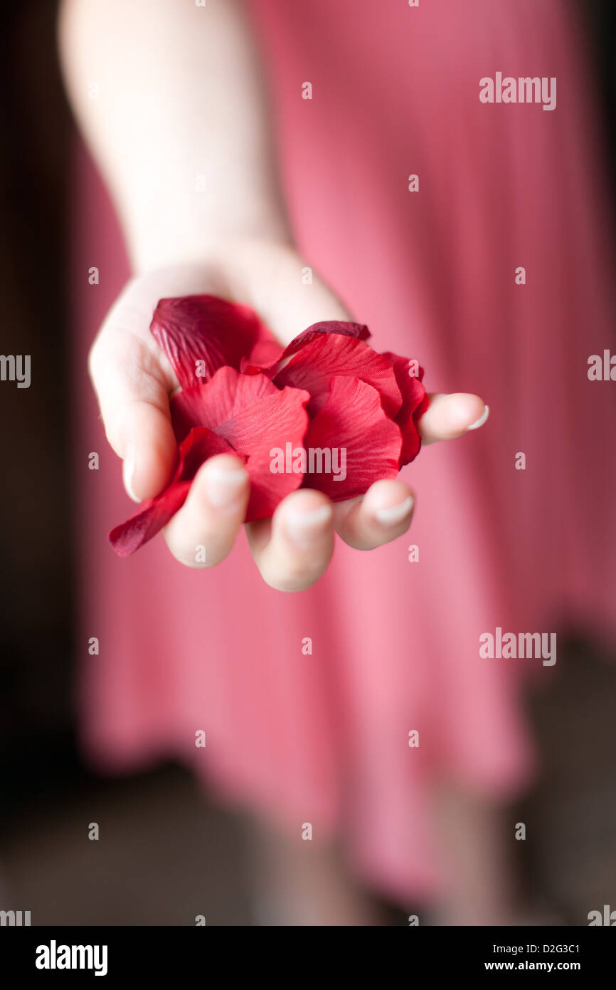 Photo of a Bridesmaid holding red confetti in her hand Stock Photo