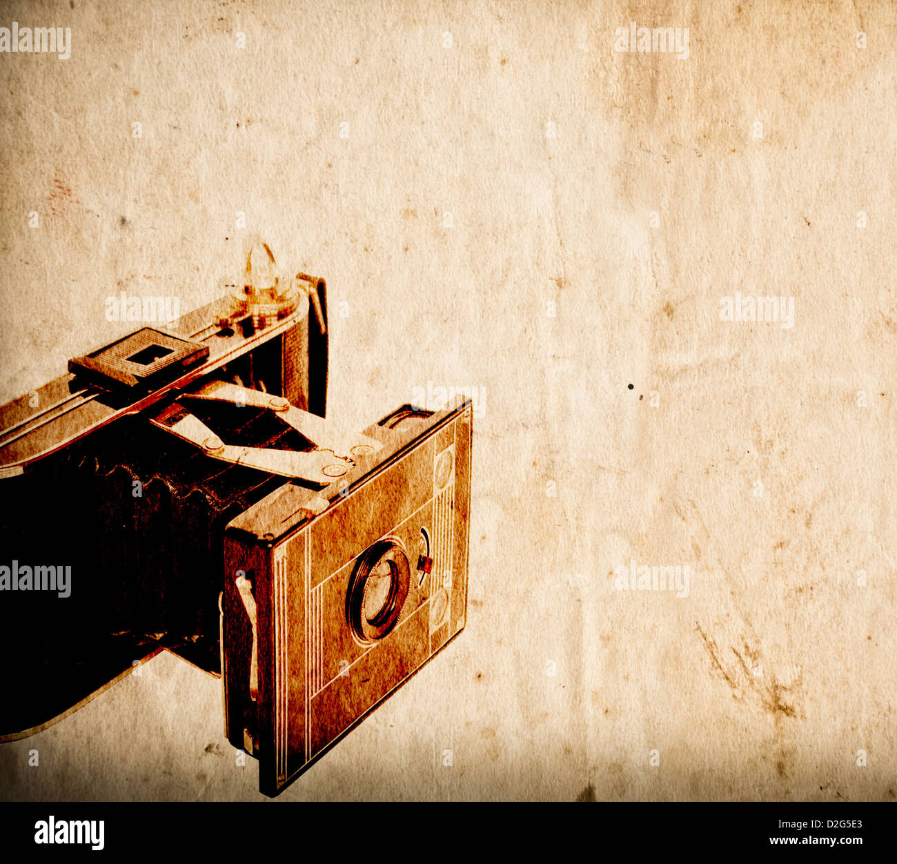 Antique camera on vintage paper background Stock Photo - Alamy