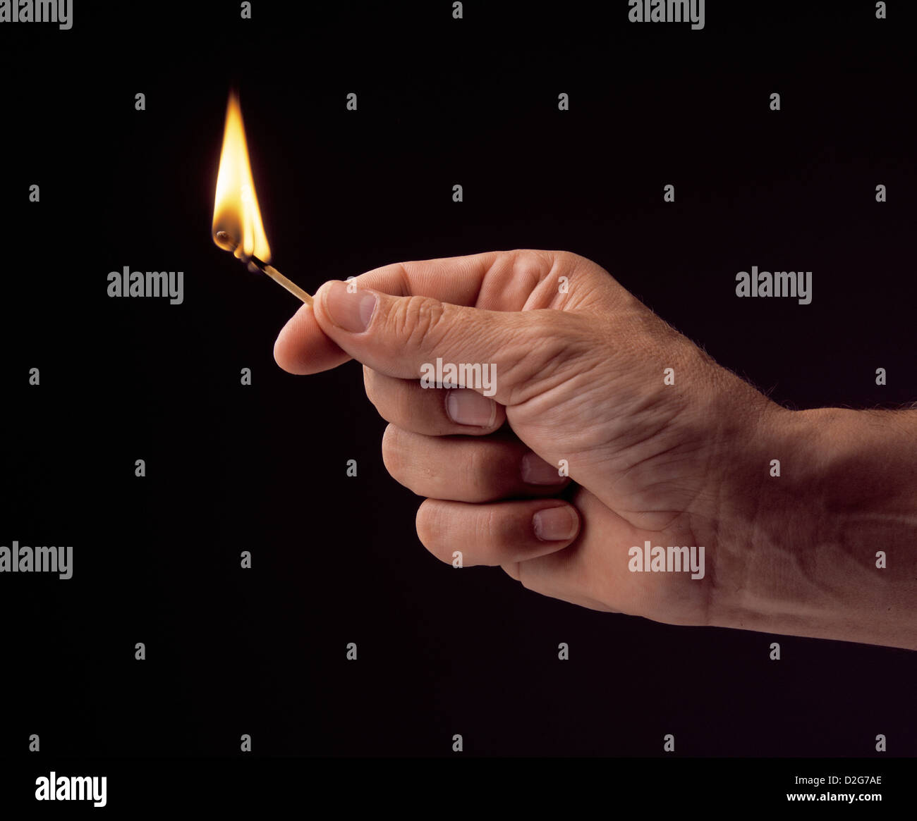 Hand holding lit match black background, studio photograph Stock Photo Alamy