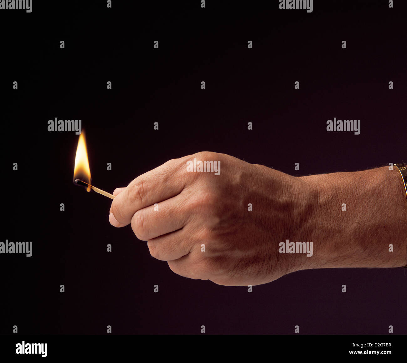 Hand holding lit match black background, studio photograph Stock Photo Alamy
