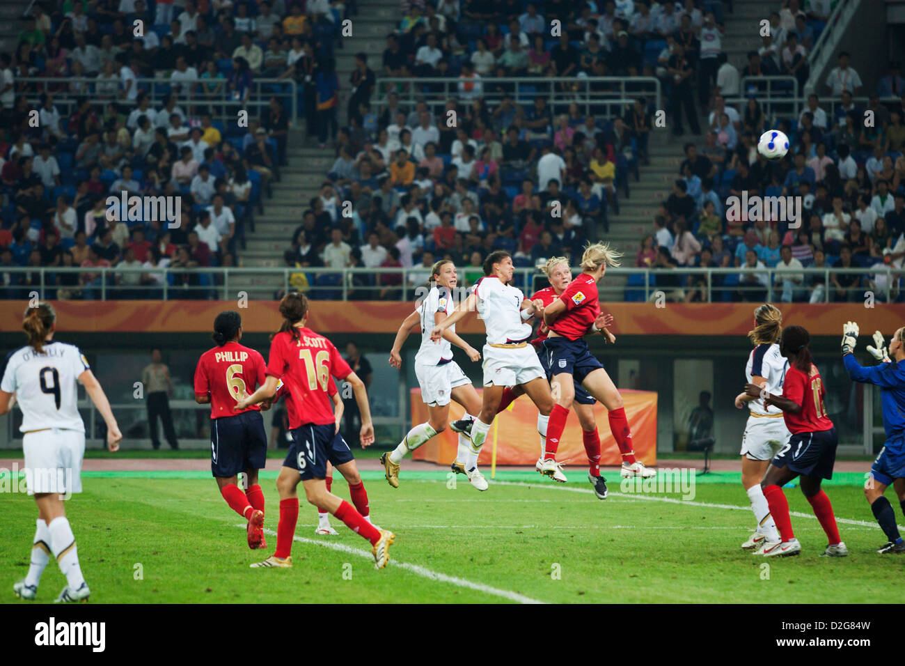 England and USA players jump for the ball during a FIFA Women's World Cup match at Tianjin Olympic Sports Center Stadium Stock Photo