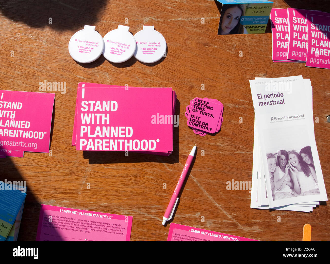 Planned Parenthood items include pens, stickers placed on shirts at information booth during MLK outdoor festival in Austin, TX Stock Photo