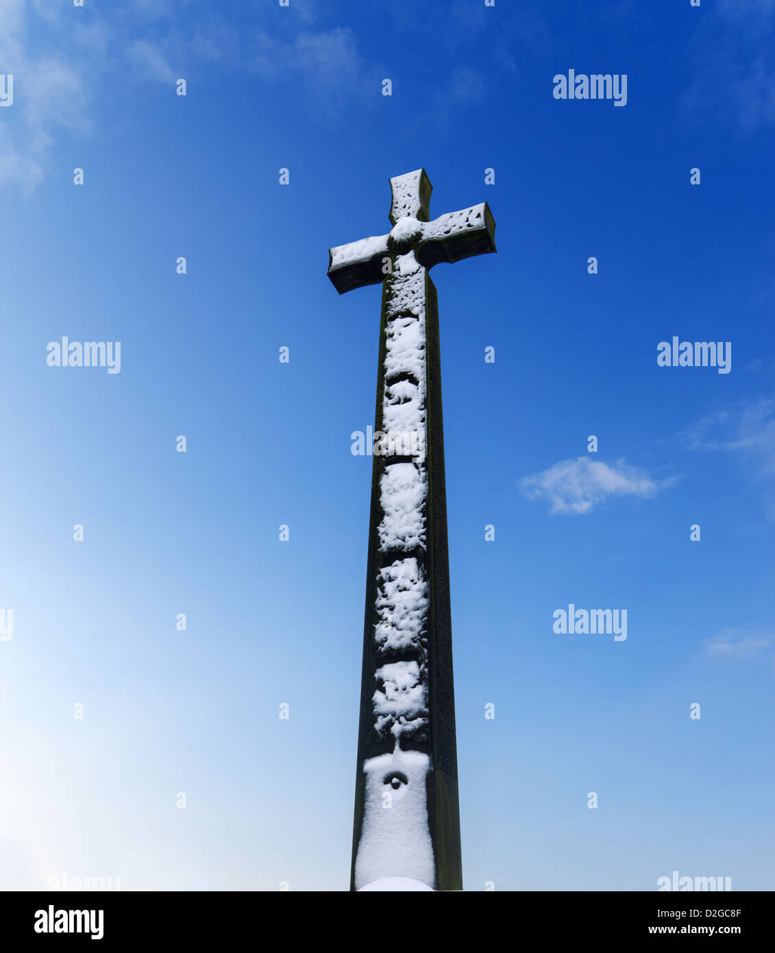 A snow covered DLI South African War Memorial, a Celtic cross against a blue sky Durham City north east England UK Stock Photo