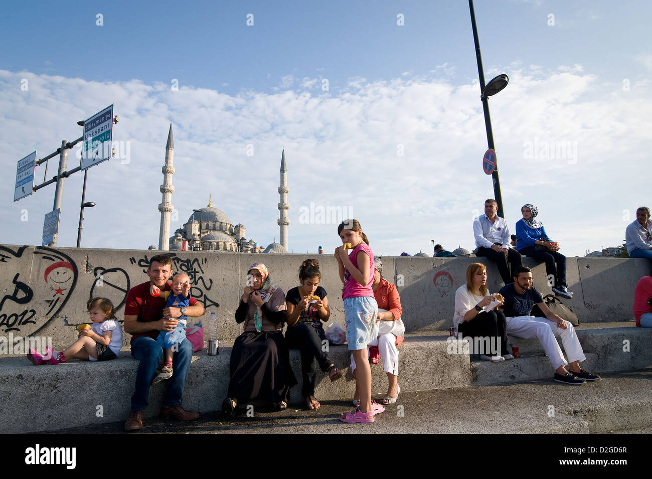 Istanbul: People enjoying an afternoon in the sun in Eminonu beside Galata Bridge. Stock Photo