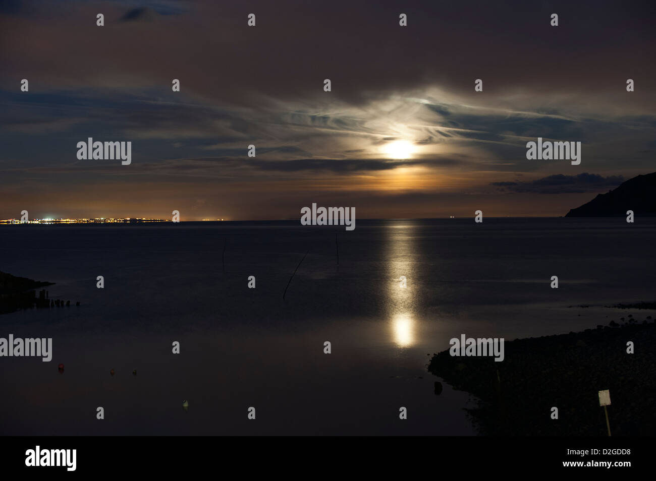 Full moon rising over the sea at Porlock Weir, Somerset, England, United Kingdom Stock Photo