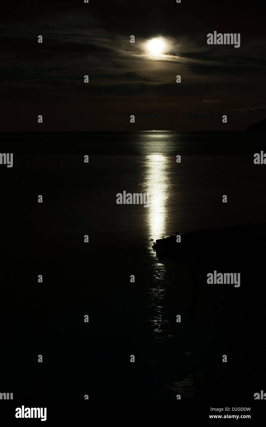 Full moon rising over the sea at Porlock Weir, Somerset, England, United Kingdom Stock Photo