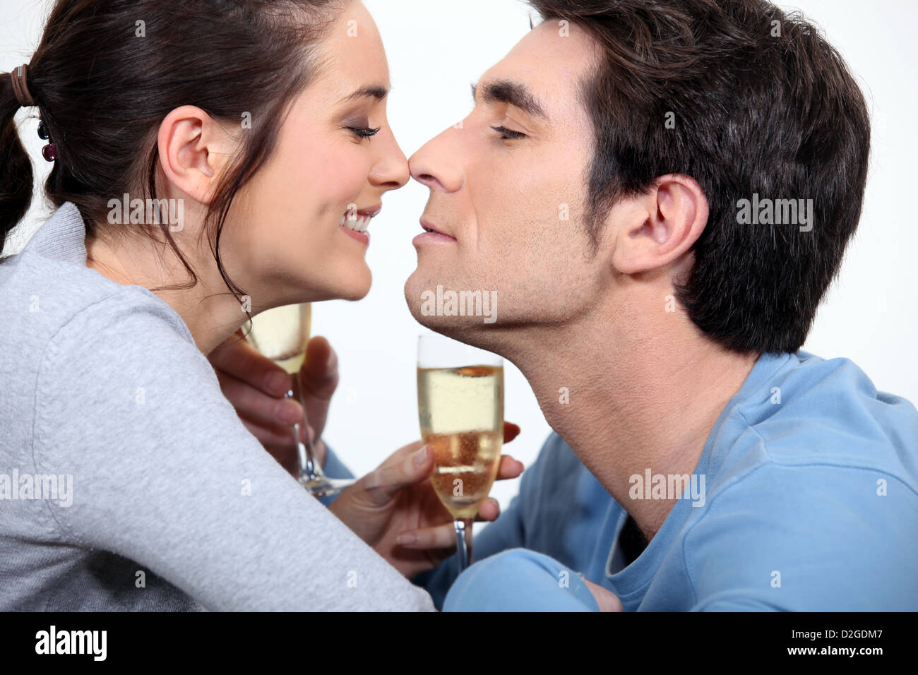 couple with flute of champagne canoodling Stock Photo