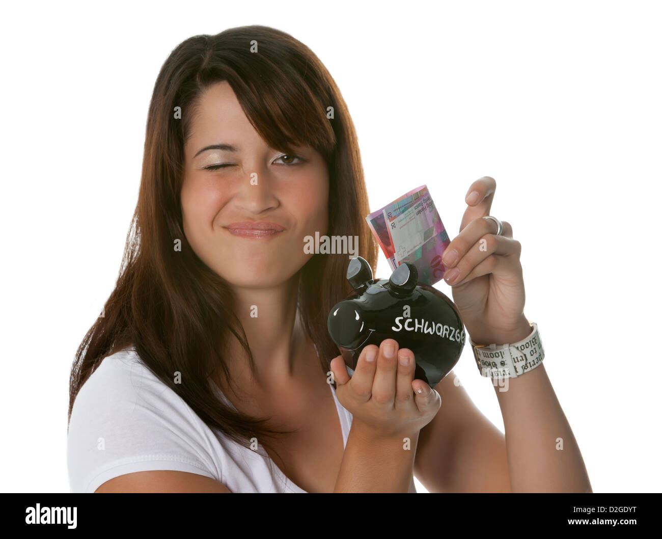Beautiful young woman putting illegal earnings into a black piggy bank Stock Photo