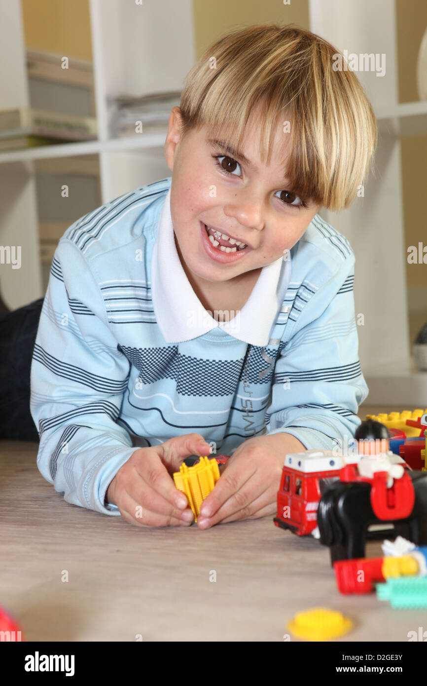 Little boy playing with toys Stock Photo - Alamy