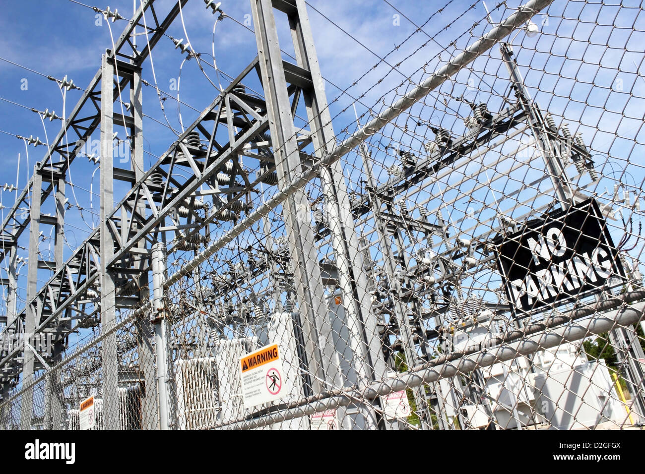 entrance and fencing around a large power station Stock Photo
