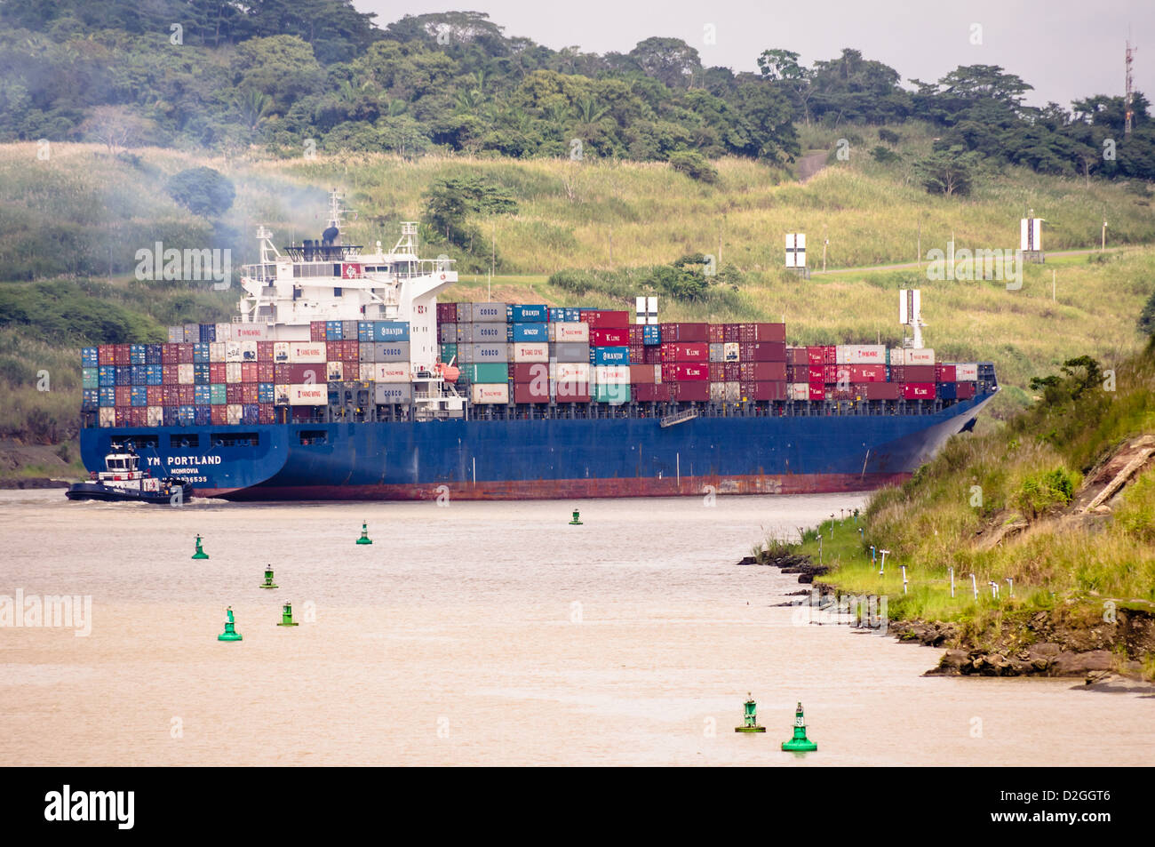 Panama Panama Canal The cargo ship YM Portland is assisted through the