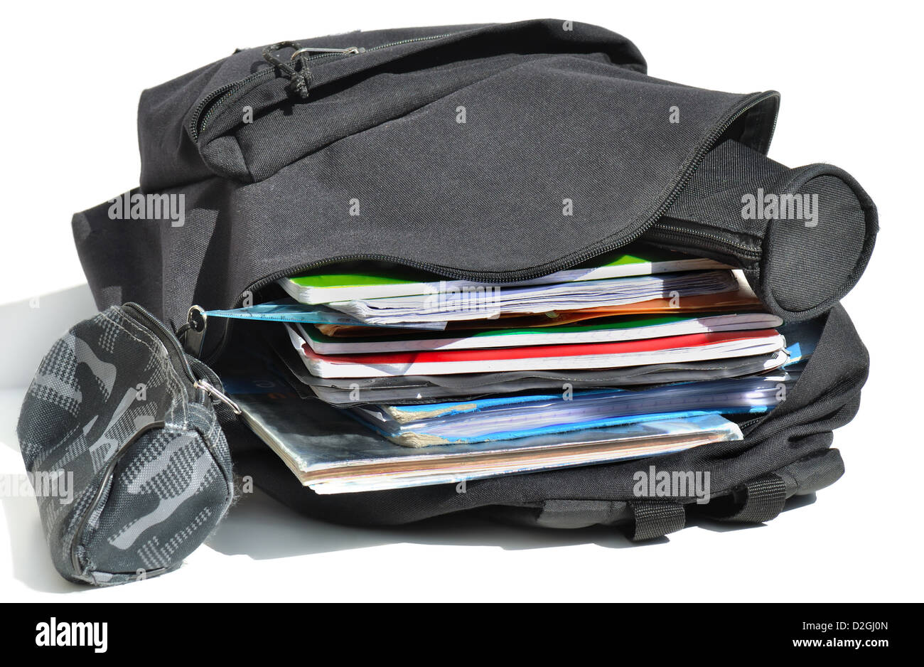 schoolbag open and filled with school matters a bit worn Stock Photo