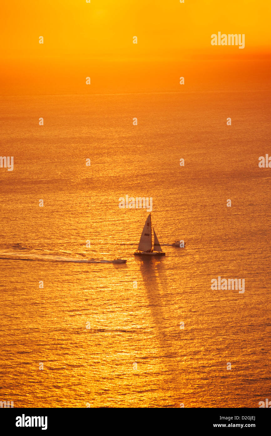 A yacht on the ocean at sunset Stock Photo - Alamy