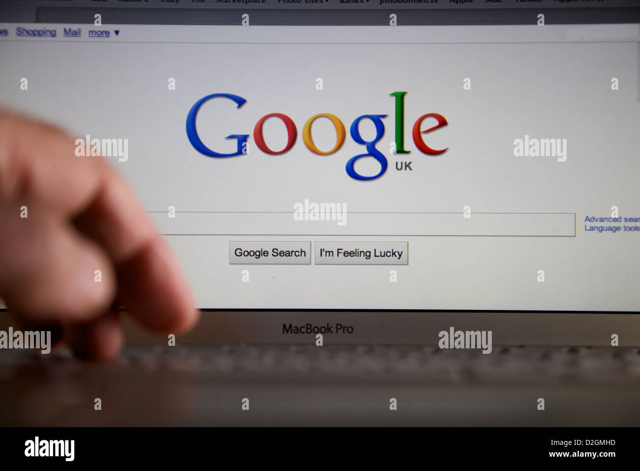 Mac computer key board and screen with Google page Stock Photo