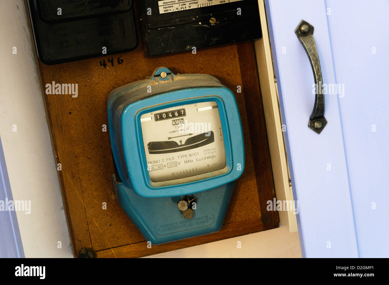A domestic electricity meter in a cupboard Stock Photo