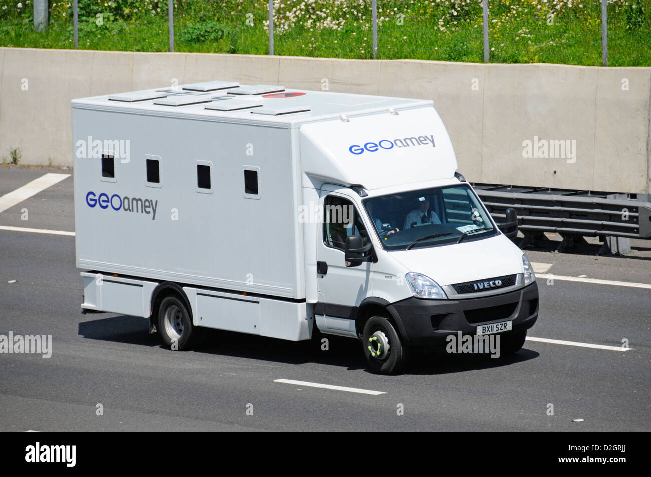GeoAmey business operate specialised lorry truck prisoner & custody transport in secure van between court prison & detention centres on uk motorway Stock Photo